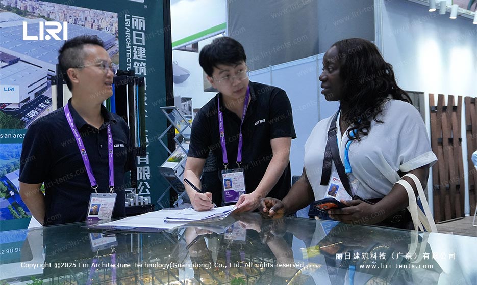 Group of Indian buyers discussing Liri modular structure model on display