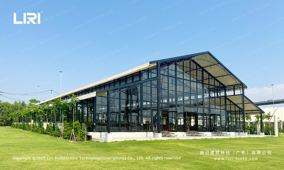 Orangery tent transparent exterior on a lawn with glass walls