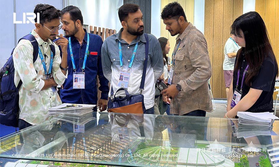Overseas buyers reviewing Liri tent product brochures at the Canton Fair booth