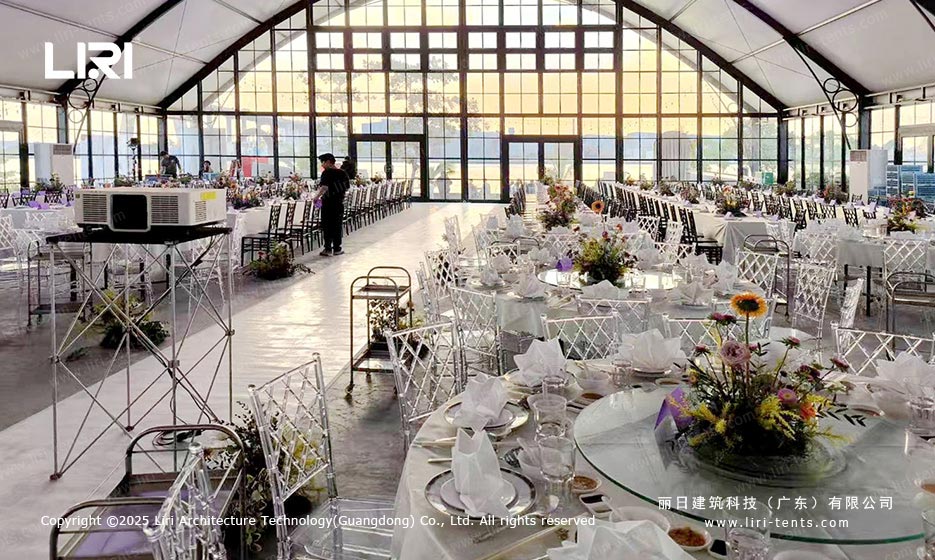 Orangery tent banquet dining setup with glass walls and round tables