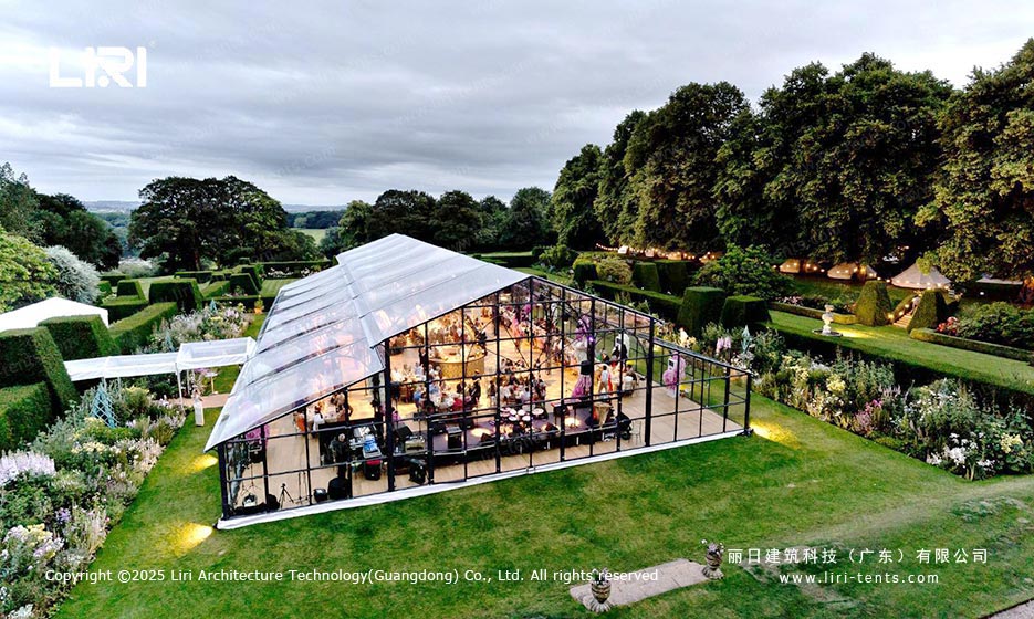 Orangery tent garden event exterior with glass walls and evening lighting