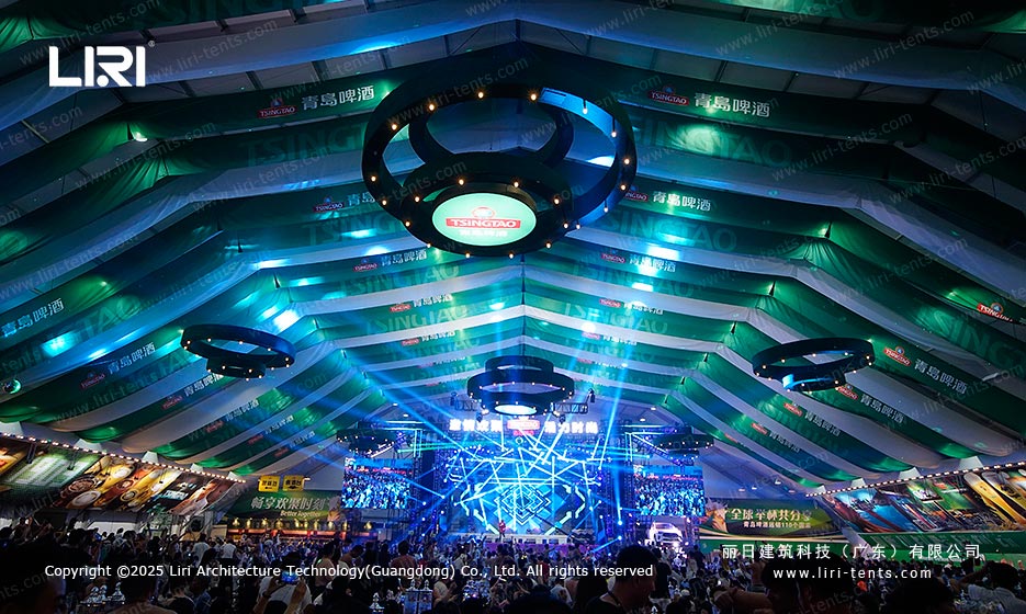 Beer festival tent interior with branded ceiling graphics and central stage