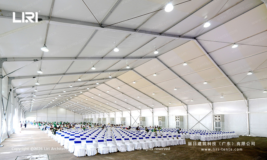 Large spectator hospitality tent interior with arranged seating