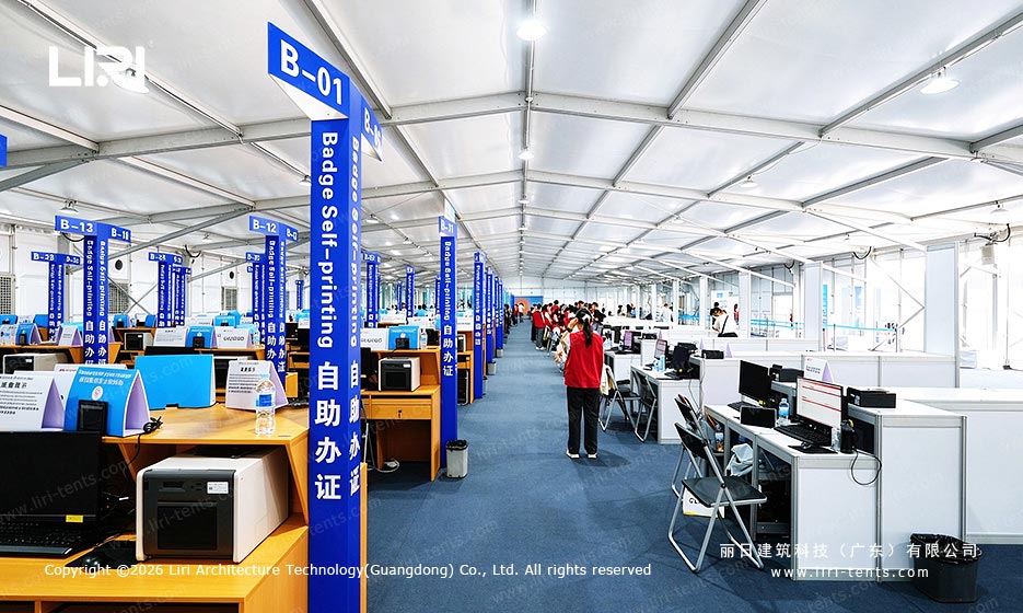Badge registration and self-printing stations inside a Canton Fair temporary tent