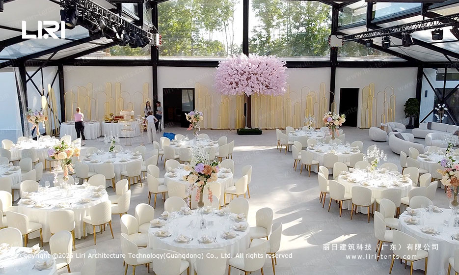 Wedding reception tables and floral decorations inside a pastoral marquee